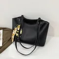 Black large tote bag with white contrast stitching and decorative yellow silk scarf accessory - Black