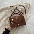 Brown crocodile embossed leather crossbody bag with vintage gold clasp and bead detail - With Pendant / Brown