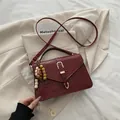 Deep red crocodile embossed handbag with gold horseshoe buckle and wooden bead accent - With Pendant / Burgundy