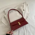 Retro burgundy baguette shoulder bag with glossy patent finish and gold metal lock - Red