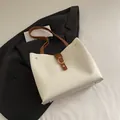 Chic two-tone white and brown tote bag with gold ring buckle and rivet accents - White