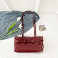 Deep red patent leather shoulder bag with buckle details and spacious interior - Red