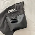 Minimalist black tote bag in oil wax PU leather with small matching pouch and long straps - Black