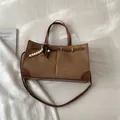 Brown woven texture tote bag with leather trim and wooden bead charm variant - With Pendant / Brown