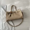 Beige woven tote bag with faux leather trim and decorative wooden bead charm - With Pendant / Off White