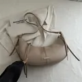 Beige faux leather hobo shoulder bag with decorative tassels and metallic accents - Khaki