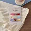 Detailed view of three colorful bear and bow hair clips on a white display card - Orange Purple Plaid Trace-less Clip