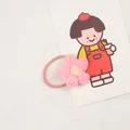 Detail of pink hand-knitted flower hair tie with soft yellow center and elastic cord - Pink