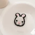 Detail of handcrafted crochet rabbit hair clip showing delicate white yarn texture - White Rabbit