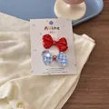 Close-up of red polka dot and blue checkered bow hair clips with rhinestones - Red Blue Large Bow