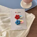 Detail of colorful resin flower hair clips with cute puppies and hello text on paper card - Blue Red Flower Duckbill Clip