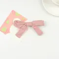 Pink fabric bow hair clip for girls featuring a soft solid color and elegant design - Pink