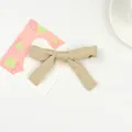 Beige fabric bow hair clip for girls with a soft matte finish and long ribbon tails - Khaki