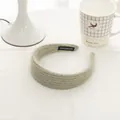 Close-up of light green knit headband featuring a white Handmade label on the inner side - Bean Green