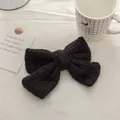 Close-up of black knitted mohair double bow hair clip with textured wool fiber detail - Versatile Black