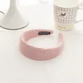 Detail of pink knitted headband with handmade label on soft wool texture - Pinkish