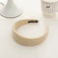 Detail of hand-made beige mohair knit headband showing thick woven texture and label - Creamy Yellow