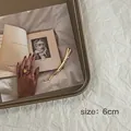 Dettaglio di un fermaglio per capelli dorato da 6cm con stelle su un libro - Stile Curvo / Oro / 6cm
