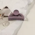 Detailed macro view of a matte purple hair claw clip on a minimalist white background - Bean Paste Purple