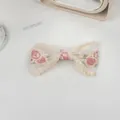 Close-up of white mesh hair clip with pink rose embroidery and delicate lace edges - Single Layer Bow