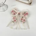 Detailansicht der Haarklammer aus Netzstoff mit zarten rosa Blumenstickereien auf Beige - Zweilagiges Band