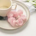 Detail of light pink organza scrunchie with soft pleated fabric and subtle shimmer texture - Pink