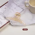 Detail view of 9.5cm amber acrylic hair claw clip with golden metal spring for women - Medium One-line Style (5#)
