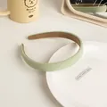Close-up of light green headband with twill fabric texture and brown non-slip lining - Milky Green