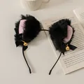 Close-up of black plush cat ears headband with pink inner lining and golden bells - Black