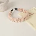 Close-up of pleated beige satin headband decorated with elegant white pearls on a desk - 29# Double Row Artificial Pearl Style
