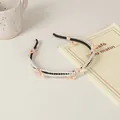 Detail of slim black headband with double-row pearls and soft pink fabric bows - 26# Double Row Artificial Pearl Style