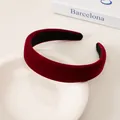 Detail of elegant wine red velvet headband with a wide padded design and non-slip lining - Burgundy