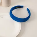 Detail of blue velvet sponge headband with HAND MADE label on white ceramic plate - Suede Sponge Blue