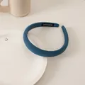 Detail of blue ribbed fabric headband with handmade label on white ceramic plate - Coarse Twill Mist Blue