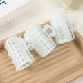 Detailed close-up of 3 self-adhesive hair rollers with green velcro and metal springs - Fresh Green