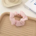 Soft pink seersucker scrunchie with pleated texture on a decorative tray - Light Pink