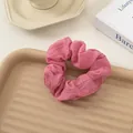 Pink seersucker scrunchie with soft pleated texture on a decorative tray - Rose Pink