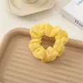 Seersucker scrunchie in bright lemon yellow with textured fabric for bun hairstyles - Yellow