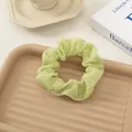 Light green seersucker scrunchie with pleated texture for hair styling and bun ties - Green
