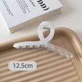 Detail view of 12.5cm cream white translucent claw clip on a stylish tray - Gradient White Ribbon