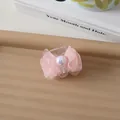 Detailansicht der Haarspange mit rosa Netzschleife, großer Perle und kleinem Design - Rosa
