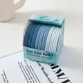 Detalle de gomas para el pelo degradadas azules en una caja de regalo a juego - Lluvia de Hielo