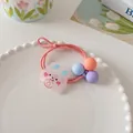 Detailed shot of a pink high-elasticity hair tie with a cartoon rabbit and colorful beads - Orange Pink Rabbit