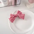 Detail view of red and white checkered bow hair clip on a white decorative plate - Hair Bow / Red Plaid (2#)