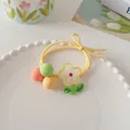 Close-up of a pastel yellow elastic hair tie with matte candy beads and daisy charms - Yellow Floral