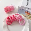 Detailansicht von 7 elastischen Haargummis mit rosa Farbverlauf in einer Vorratsdose - Rosa-Serie Farbverlauf Netz-Stil