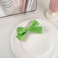 Dettaglio di un fermaglio per capelli a fiocco in tessuto verde su piatto di ceramica - 29# Cotone Lino - Verde