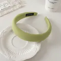 Gros plan du serre-tête rembourré vert clair avec étiquette faite main sur assiette - Vert Herbe