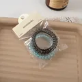 Dettaglio di elastici per capelli a spirale traslucidi neri e blu su un vassoio - 1# Azzurro Chiaro/grigio Scuro