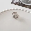 Detailed macro view of a silver metal mini hair claw clip with hollow smiley face design - Smile Face - Silver